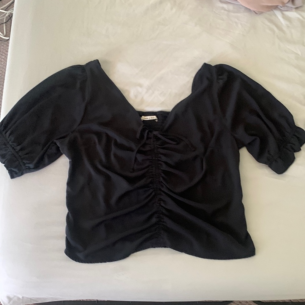 Smocked back, ruffle sleeve black top